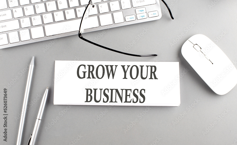 Poster grow your business text on paper with keyboard on grey background