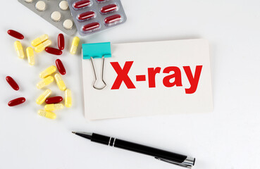 X-RAY text written in a card with pills. Medical concept.