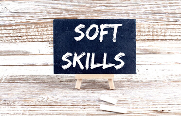 SOFT SKILLS text on the Miniature chalkboard on wooden background