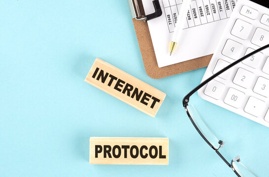 INTERNET PROTOCOL text written on wooden block with clipboard,eye glasses and calculator Business concept.