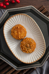Delicious Cantonese moon cake for Mid-Autumn Festival food mooncake on wooden table background.