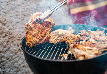 man chef cooking chicken meat on grill outdoor