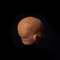 Damaged Dirty Doll head on black background