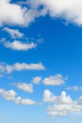 Blue sky background with cumulus clouds