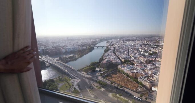 wide angle view Revealing Curtains And Looking Outside Sevilla aerial view from skyscrapper tower