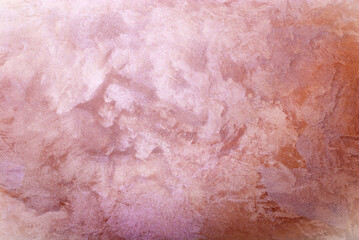 Pink colored abstract textured background. Decorative plaster on the wall