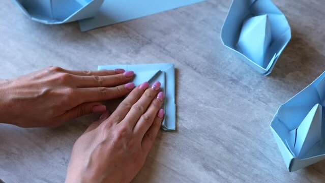 Woman hands making paper boat