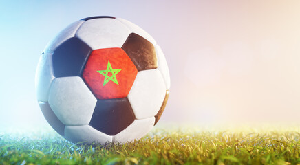 Football soccer ball with flag of Marocco on grass