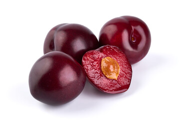 Juicy Red plums with a half, isolated on white background.