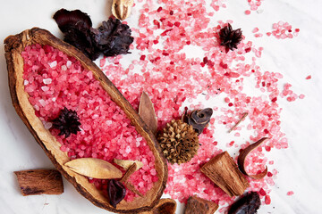 Iodized pink bath salt, dried plants and herbs, flowers,coconut and cacao in the spa. Body and...