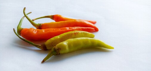 Red and green chilies isolated on a white background. Raw food concept. Hot and spicy. Top view....
