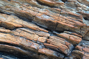 Layered rocks. The texture of the stone.