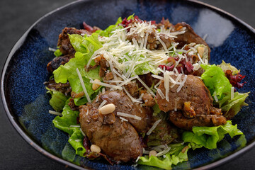 Warm salad with liver and cheese, artistic processing