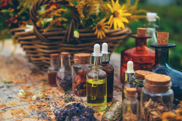 Medicinal herbs and tinctures on the table. Selective focus.