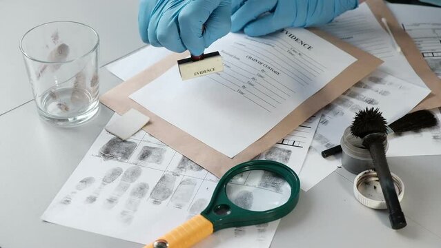 forensic expert puts a stamp on a paper envelope with evidence