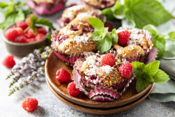 Healthy dessert. Vegan gluten-free pastry. Oatmeal banana muffins with raspberry and coconut flakes on a stone table.