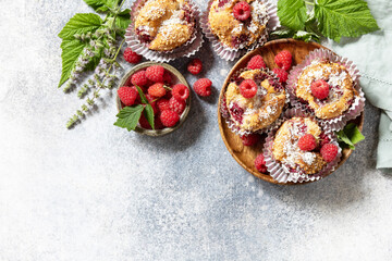 Healthy dessert. Vegan gluten-free pastry. Oatmeal banana muffins with raspberry and coconut flakes on a stone table. View from above. Copy space.