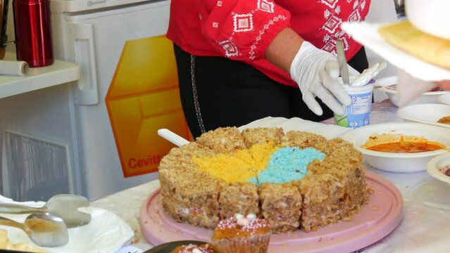 June 25, 2022 - Offenburg, Germany: Homemade cakes, freshly baked biscuit cake honey cake with a beautifully laid out heart in the form of symbolic blue-yellow colors of the flag of Ukraine