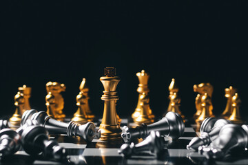 Close-up King standing on a chessboard. There's a falling chess in front, leadership. teamwork Business Team Challenges, Global Industry Winners.