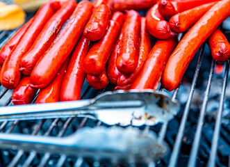 Grilling sausages on barbecue grill outdoor