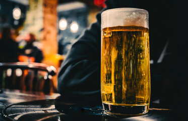 glass of beer on table at the bar or pub