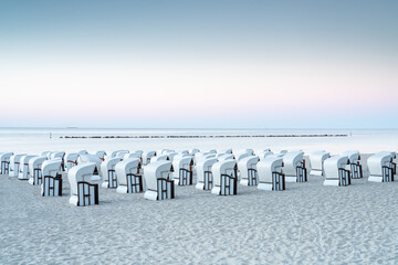 Empty roofed wicker beach chairs on the beach