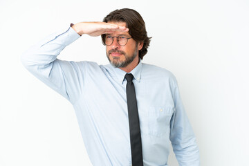 Senior dutch business man isolated on white background looking far away with hand to look something