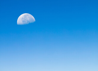 Blue sky with half moon.