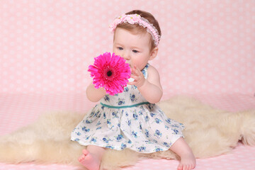 little girl against a pink background