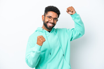 Young Brazilian man isolated on white background celebrating a victory