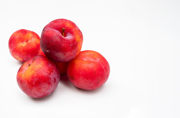 Freshly harvested  sweet juicy plums  on a white background