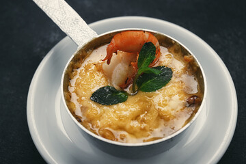 Julienne with shrimps on a dark background