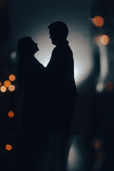 Romantic Silhouettes of couple in the lights of love. Love of both. He and She	