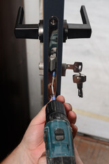 Installation of lock and door handle to interior doors, locksmith works with doors.