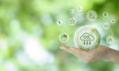 Reduction of carbon emissions, carbon neutral concept. Net zero greenhouse gas emissions target..Reducing carbon footprint concept..Decreasing CO2 emissions target symbol on green view background.