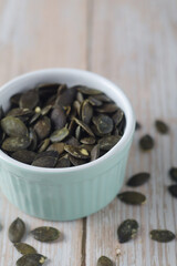 Peeled pumpkin seeds in a small bowl	