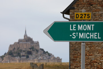 sign and arrow with the inscription LE MONT ST MICHEL indicating the famous abbey on the island in...