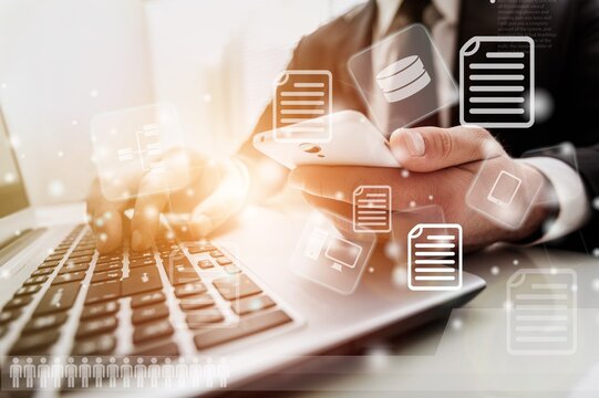 Business person working on a laptop computer to document management online documentation database digital file storage system software records keeping database technology file access doc sharing.