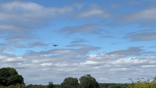 British army paratroopers (3 PARA) parachuting on an overhead assault , wearing body armour and webbing with weapons and daysacks suspended by rope below, blue sky