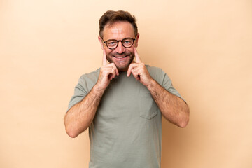 Middle age caucasian man isolated on beige background smiling with a happy and pleasant expression