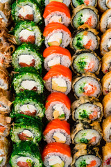 set of different colorful maki sushi rolls sushi texture background