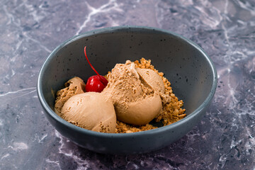 Tasty appetizing chocolate ice cream with cherry and pistachios