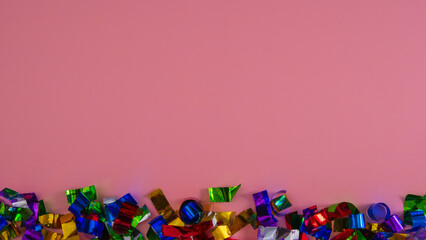 Fototapeta na wymiar Christmas confetti on a pink background.