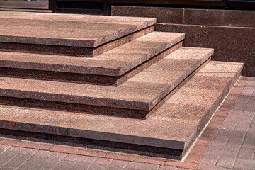 corner granite staircase with stone steps rise to the threshold building facade architecture...