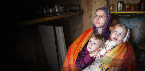 Frightened children with their mother hide in the cellar from the bombings. Kyiv. Ukraine. 8 May...
