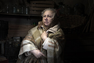 Frightened woman hide from explosions in the basement. During the sirens due to the shelling of Kyiv. Ukraine. 26 February 2022