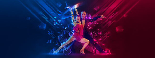 Elegant young couple of dancers dancing samba, cha-cha-cha, rumba, paso doble over dark background with neon fluid elements. Art, beauty, dance concept