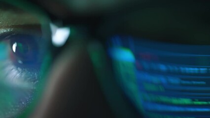 Closeup portrait of software engineer working on computer. Line of hack code run in reflection. Developer or hacker working on innovative application using computer. Big data or programming concept