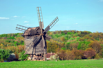Fototapeta na wymiar Traditional old windmill in the midle of the field near Kyiv, Ukraine.