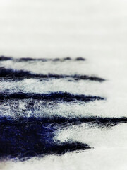 macro texture of blue paint on white fabric